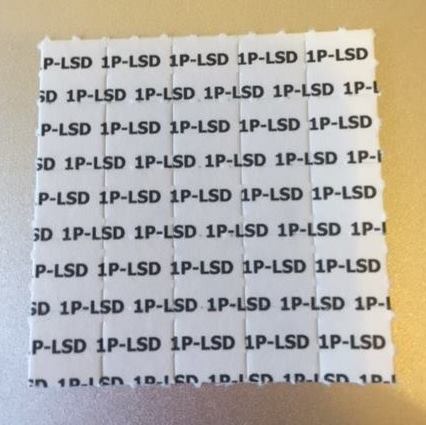 1P-LSD Blotters 100 mcg research chemical on white perforated paper